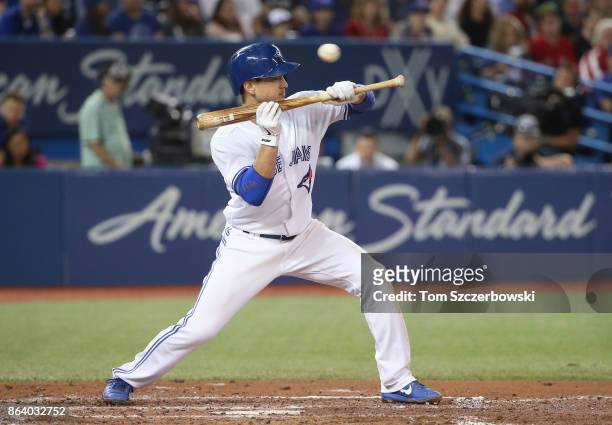 Darwin Barney of the Toronto Blue Jays pulls back a bunt attempt as he takes a high pitch in the fourth inning during MLB game action against the...