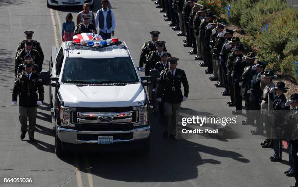 An honor guard escorts the body of Las Vegas police officer Charleston Hartfield to his funeral, October 20, 2017 in Henderson, Nevada. Hartfield was...