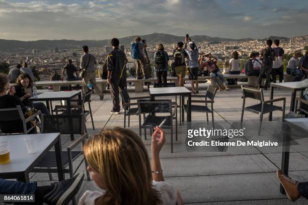 Visitors enjoy the terrace of the National Art Museum of Catalonia as the Spanish government is to take steps to suspend Catalonia's autonomy by...