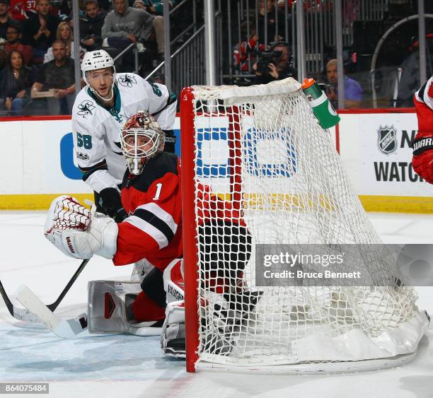 Melker Karlsson of the San Jose Sharks scores at 14:11 of the first period against Keith Kinkaid of the New Jersey Devils at the Prudential Center on...