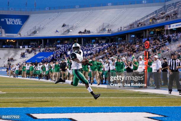 Tyler King of the Marshall Thundering Herd runs for a 15-yard touchdown in the first quarter of a game against the Middle Tennessee Blue Raiders at...