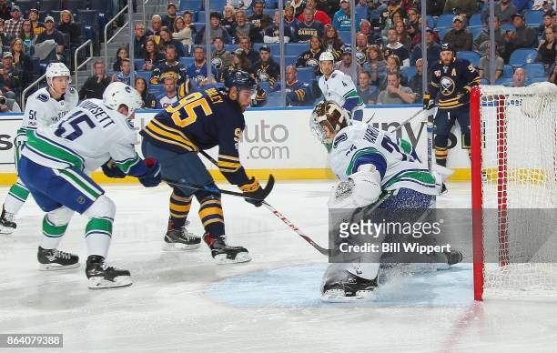 Justin Bailey of the Buffalo Sabres scores a first period goal against Jacob Markstrom of the Vancouver Canucks during an NHL game on October 20,...