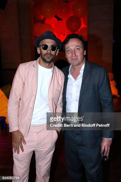 Artist JR and Emmanuel Perrotin attend the "Bal Jaune Elastique 2017" : Dinner Party at Palais Brongniart during FIAC on October 20, 2017 in Paris,...
