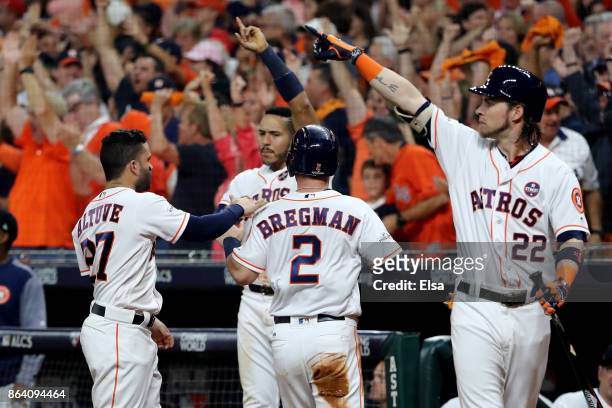 Alex Bregman of the Houston Astros celebrates with his teammates after scoring off of Brian McCann RBI double against the New York Yankees during the...