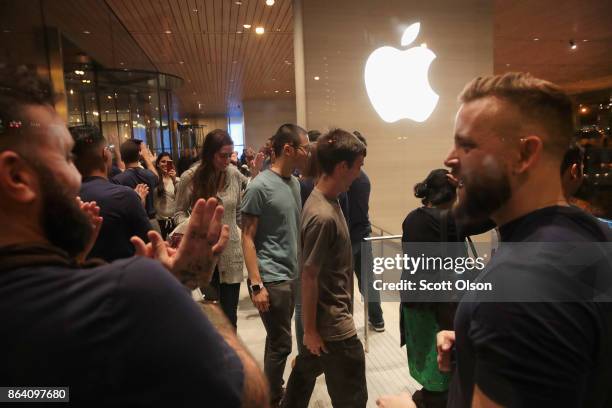 Guests attend the grand opening of Apple's Chicago flagship store along Michigan Avenue on October 20, 2017 in Chicago, Illinois. The glass-sided...