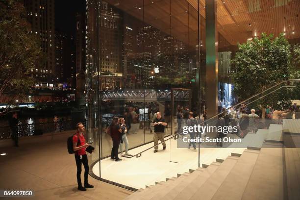 Guests attend the grand opening of Apple's Chicago flagship store along Michigan Avenue on October 20, 2017 in Chicago, Illinois. The glass-sided...