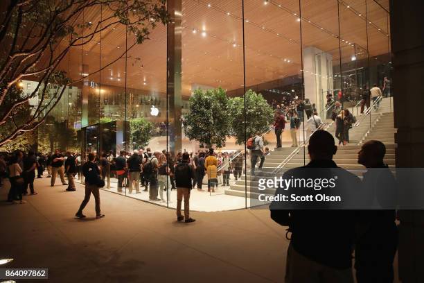 Guests attend the grand opening of Apple's Chicago flagship store along Michigan Avenue on October 20, 2017 in Chicago, Illinois. The glass-sided...