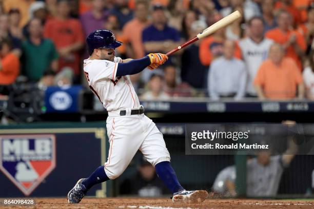 Jose Altuve of the Houston Astros hits a single to left field to score Evan Gattis and Brian McCann against Luis Severino of the New York Yankees...