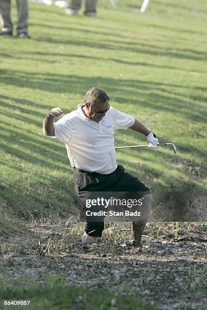 Fuzzy Zoeller attempts to hit his ball out of the muck along the 18th during the second round of the Bruno's Memorial Classic, May 21 held at...