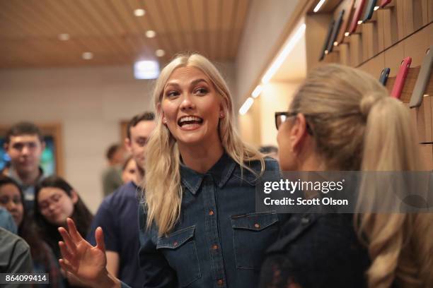 Fashion model Karlie Kloss greets guests during the grand opening of Apple's newest store located on Michigan Avenue along the Chicago River on...