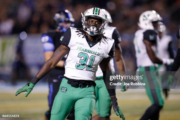 Omari Cobb of the Marshall Thundering Herd reacts after a defensive stop on fourth down in the fourth quarter of a game against the Middle Tennessee...