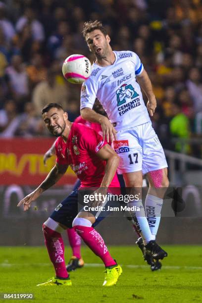 Mario Osuna of Morelia and Mauro Boselli of Leon fight for the ball during the 14th round match between Morelia and Leon as part of the Torneo...