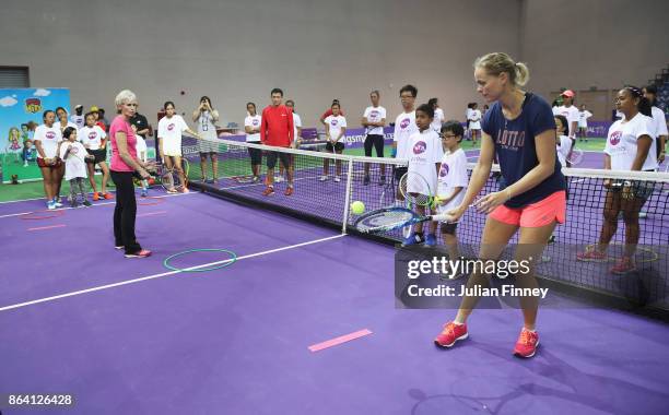 Judy Murray and Anna-Lena Groenefeld of Germany take part during Community Day prior to the BNP Paribas WTA Finals Singapore presented by SC Global...