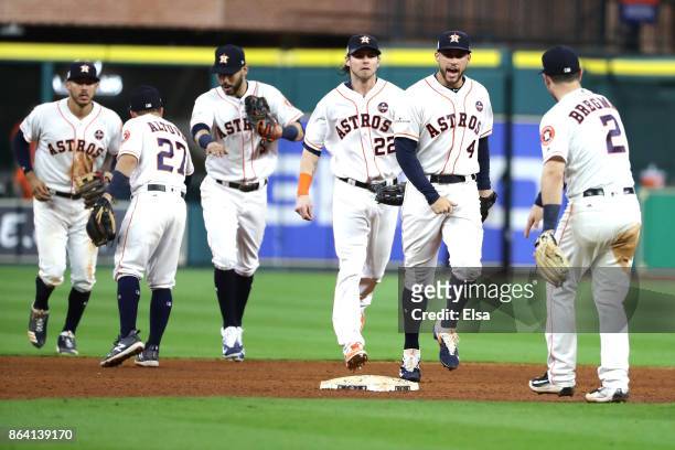 George Springer and Alex Bregman of the Houston Astros celebrates with their teammates after defeating the New York Yankees with a score of 7 to 2 in...
