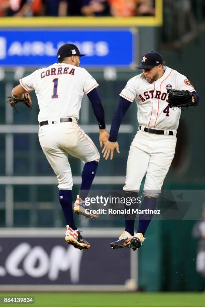 Carlos Correa and George Springer of the Houston Astros celebrate after defeating the New York Yankees with a score of 7 to 1 in Game Six of the...