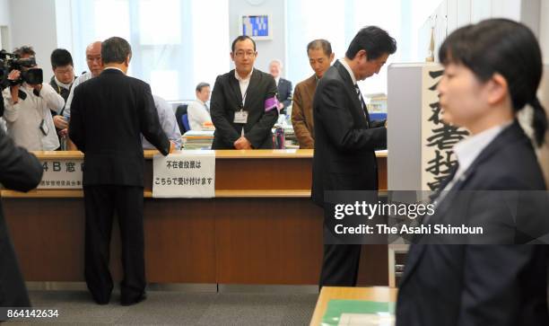 Prime Minister and ruling Liberal Democratic Party President Shinzo Abe and Liberal Party leader Ichiro Ozawa are seen at a polling station for...