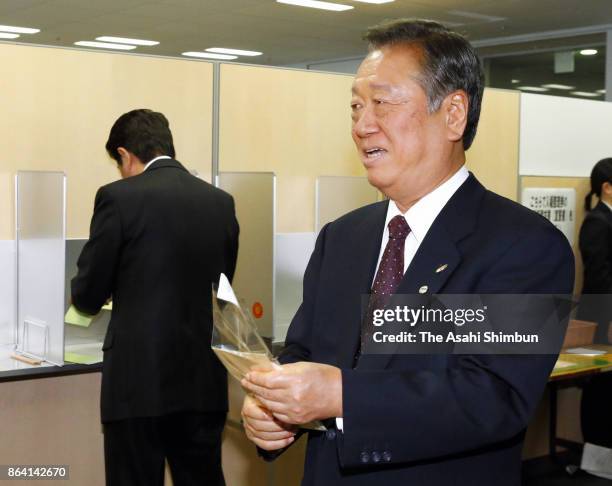 Prime Minister and ruling Liberal Democratic Party President Shinzo Abe and Liberal Party leader Ichiro Ozawa are seen at a polling station for...