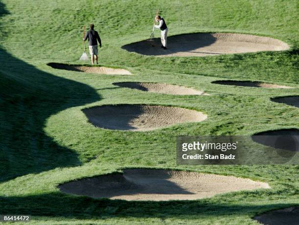 Ground crews keep bunkers clean before the second round of The International held at Castle Pines Golf Club, August 6 Castle Rock, CO.
