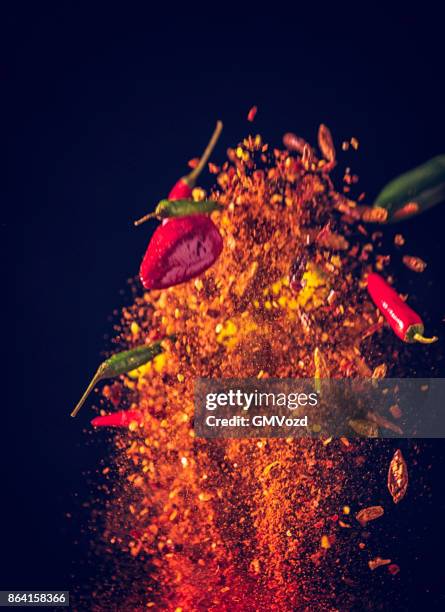 spice mix food explosion with chili peppers and chili powder - seasoning mid air stock pictures, royalty-free photos & images