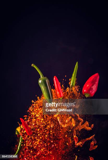 spice mix food explosion with chili peppers and chili powder - red pepper stock pictures, royalty-free photos & images