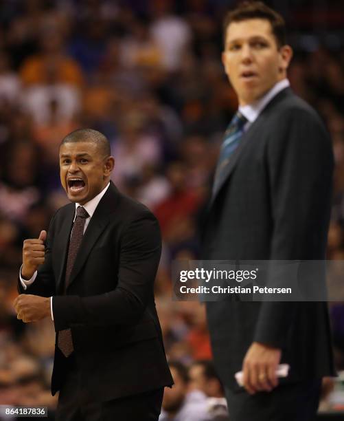 Head coach Earl Watson of the Phoenix Suns reacts alongside Luke Walton of the Los Angeles Lakers during the first half of the NBA game at Talking...