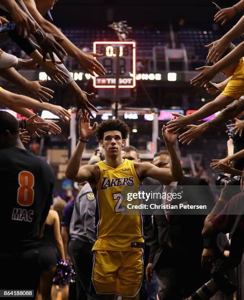 Lonzo Ball of the Los Angeles Lakers high fives fans as he walks off the court following the NBA game against the Phoenix Suns at Talking Stick...