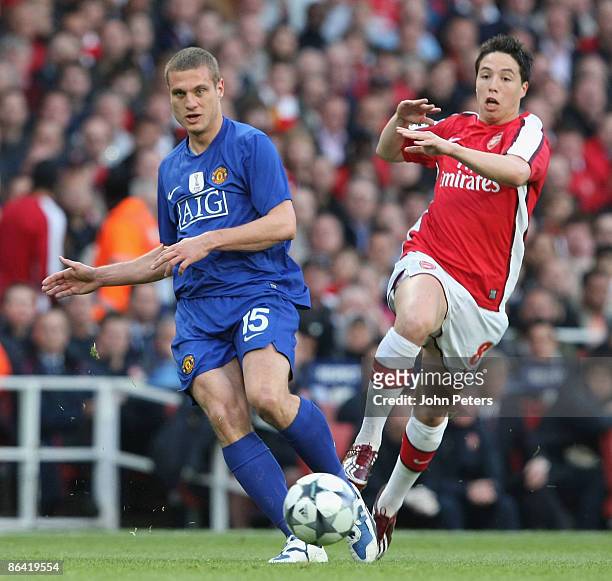 Nemanja Vidic of Manchester United clashes with Samir Nasri of Arsenal during the UEFA Champions League Semi-Final Second Leg match between Arsenal...