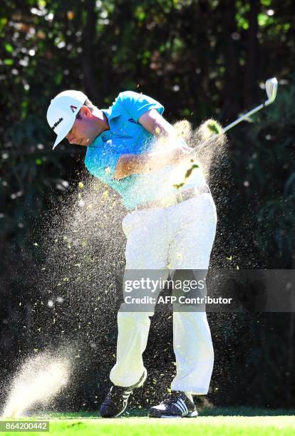 Chez Reavie of the US tees off on the 7th hole during the third round of the CJ Cup at Nine Bridges in Jeju Island on October 21, 2017. / AFP PHOTO /...