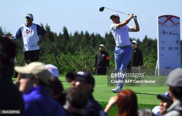 Justin Thomas of the US tees off on the 9th hole during the third round of the CJ Cup at Nine Bridges in Jeju Island on October 21, 2017. / AFP PHOTO...