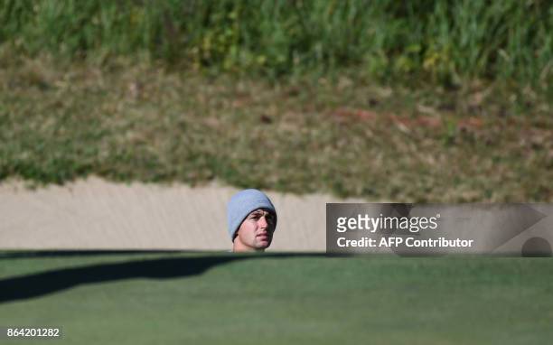 Ollie Schniederjans of the US looks on after hitting a bunker shot on the 3rd green during the third round of the CJ Cup at Nine Bridges in Jeju...
