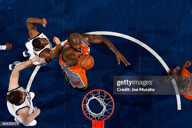 Shaquille O'Neal of the Phoenix Suns goes to the basket against Mike Conley and Marc Gasol of the Memphis Grizzlies during the game on April 10, 2009...