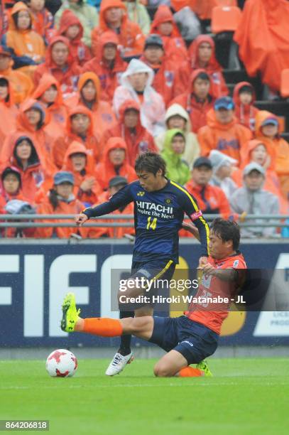 Junya Ito of Kashiwa Reysol is tackled by Kazuma Takayama of Omiya Ardija during the J.League J1 match between Omiya Ardija and Kashiwa Reysol at...