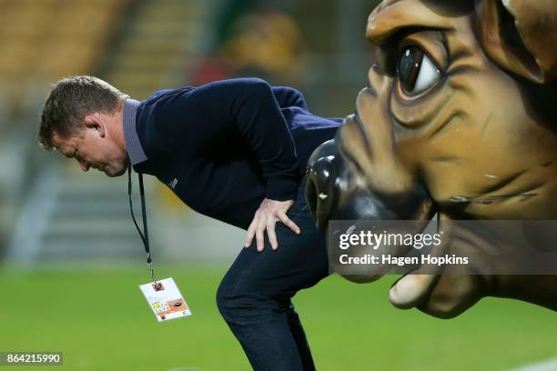 Assistant coach Greg Somerville of Tasman stretches in front of Taranaki mascot, Ferdinand the Bull , during the Mitre 10 Cup Semi Final match...