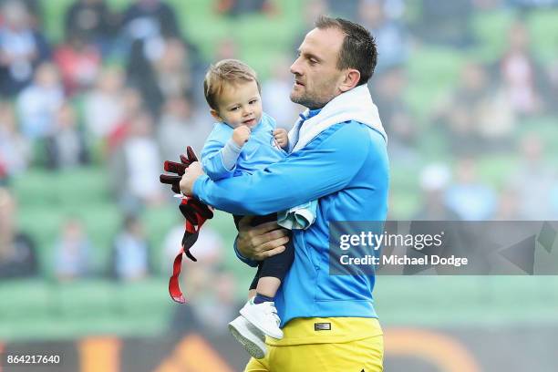 Goal Keeper Eugene Galekovic of the City enters the arena with his son during the round three A-League match between Melbourne City and the...