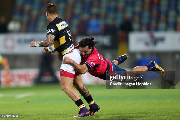 Declan O'Donnell of Taranaki is tackled by James Lowe of Tasman during the Mitre 10 Cup Semi Final match between Taranaki and Tasman at Yarrow...