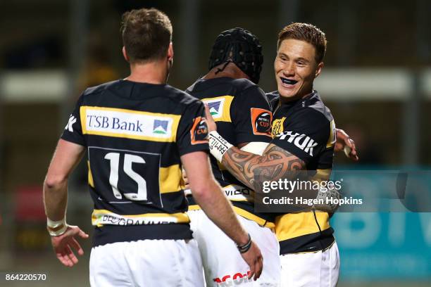 Declan O'Donnell of Taranaki celebrates with Pita Sowakula and Marty McKenzie after scoring a try during the Mitre 10 Cup Semi Final match between...