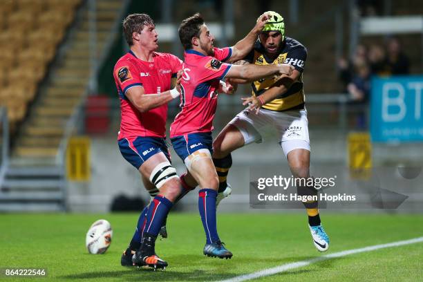 Charlie Ngatai of Taranaki is pushed by Mitchell Hunt of Tasman after scoring a try during the Mitre 10 Cup Semi Final match between Taranaki and...