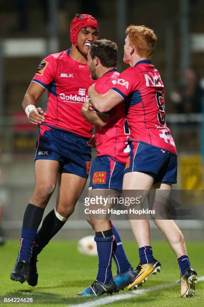 Mitchell Hunt of Tasman celebrates with Finlay Christie and Tima Faingaanuku after scoring a try during the Mitre 10 Cup Semi Final match between...