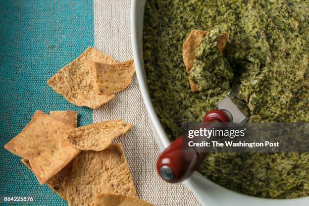 Warm Spinach and Artichoke Dip in a oval bowl with chips shot on January 24th, 2017 in Washington DC.
