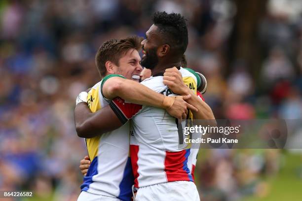 Josh Turner and Nick Duffy of the Rays congratulate Robaleibau Buaserau after crossing for a try during the round eight NRC match between Perth and...