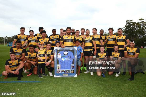 Pekahou Cowan of the Spirit poses with team mates after being presented Western Force memorabilia item following the round eight NRC match between...