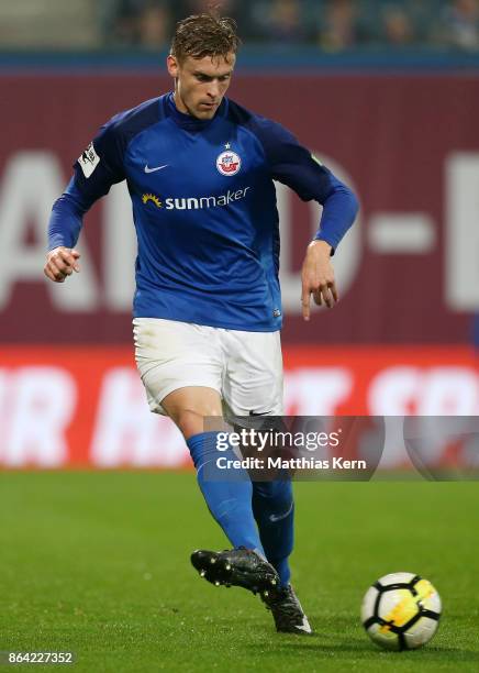 Oliver Huesing of Rostock runs with the ball during the third league match between FC Hansa Rostock and VfL Osnabrueck at Ostseestadion on October...