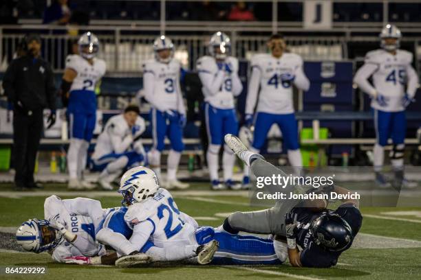 Wide receiver McLane Mannix of the Nevada Wolf Pack hits the ground after getting tangled up with defensive back Kyle Floyd of the Air Force Falcons...