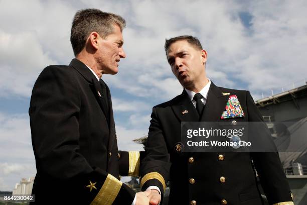 Rear Adm. Marc Dalton, the Commander of US aircraft carrier Ronald Reagan and Brad Cooper, the Commander of U.S. Naval Forces Korea speak during a...