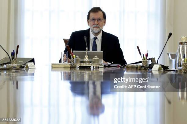 Spanish Prime Minister Mariano Rajoy presides a crisis cabinet meeting at the Moncloa Palace on October 21, 2017 in Madrid. Spain's government kicked...