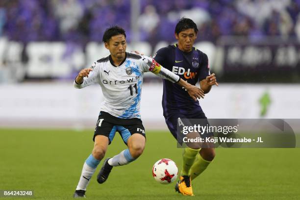 Yu Kobayashi of Kawasaki Frontale and Hiroki Mizumoto of Sanfrecce Hiroshima compete for the ball during the J.League J1 match between Sanfrecce...