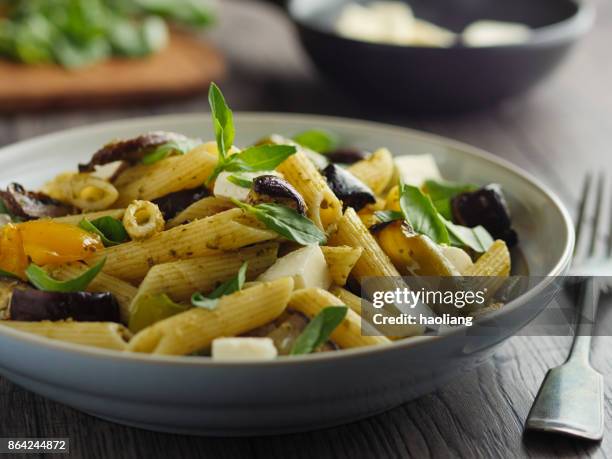 roasted vegetable pasta salad - penne pesto stock pictures, royalty-free photos & images