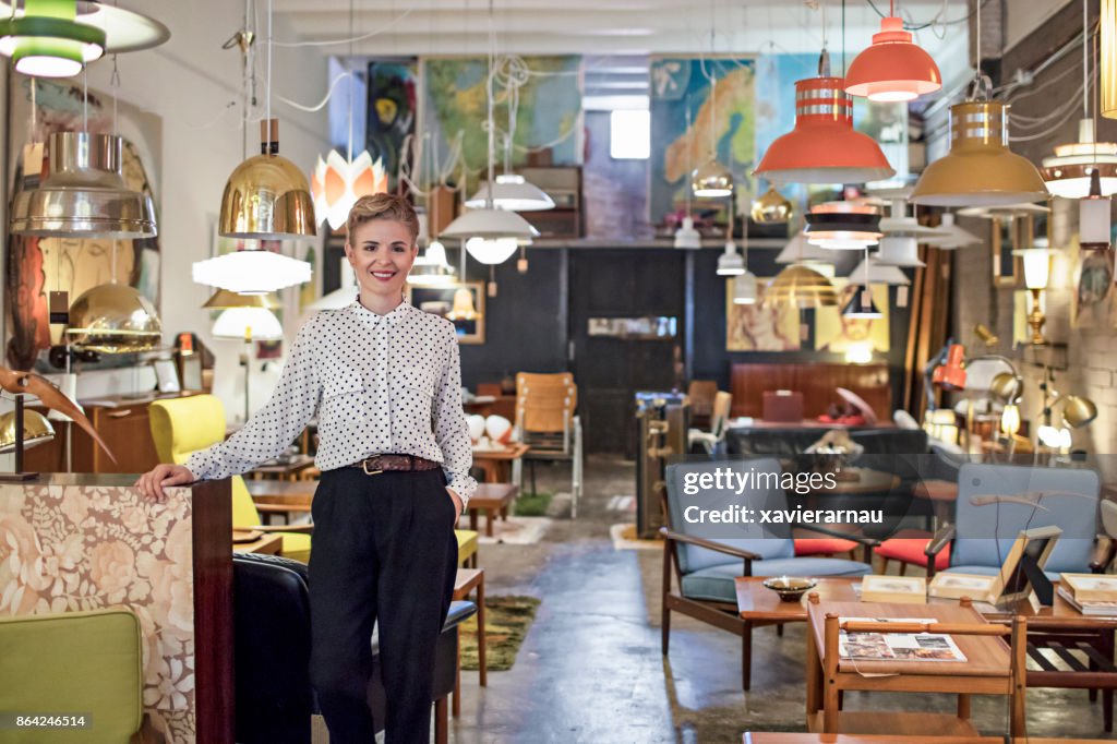 Portrait of a female business owner standing in her furniture store