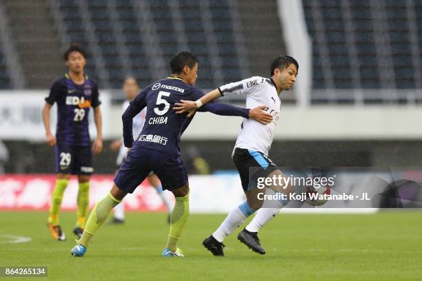 Yu Kobayashi of Kawasaki Frontale controls the ball under pressure of Kazuhiko Chiba of Sanfrecce Hiroshima during the J.League J1 match between...