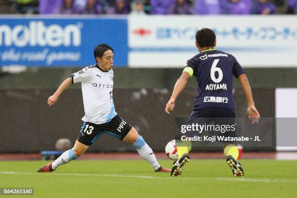 Koji Miyoshi of Kawasaki Frontale takes on Toshihiro Aoyama of Sanfrecce Hiroshima during the J.League J1 match between Sanfrecce Hiroshima and...